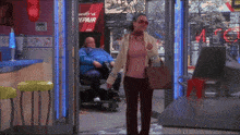 a man in a wheelchair is sitting in front of a red sign that says repair