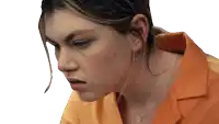a close up of a woman 's face wearing an orange shirt