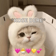 a cat wearing a bunny hat with hearts around it .