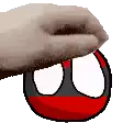 a hand is holding a red and black ball with a white and black face .