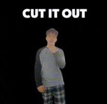 a man is standing in front of a black background with the words cut it out above him .