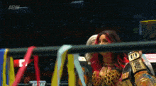a woman in a wrestling ring with a belt that says ufc on it