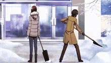 a man is shoveling snow while a woman stands next to him .