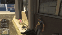 a man in a black shirt with the number 19 on it stands in front of a building in a video game