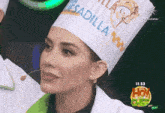 a woman wearing a chef hat that says mesadilla