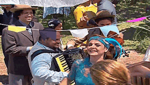 a man playing an accordion in front of a woman
