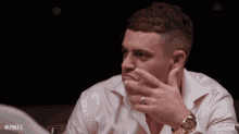 a man wearing a watch and a wedding ring is sitting at a table with the hashtag mafs