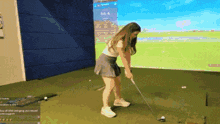 a woman is swinging a golf club in front of a screen that says 65.4