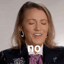 a woman with her eyes closed says no