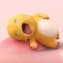a yellow cartoon dinosaur is laying on its back with its mouth open and drooling .
