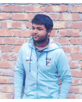 a man wearing a blue sweatshirt with the word captain on it