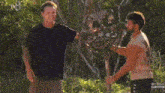 a man with a beard is wearing a black tank top with the word survivor on the bottom