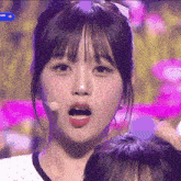 a close up of a girl 's face with a microphone in front of her and the word scale on the bottom