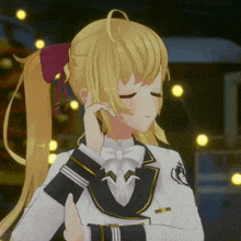 a girl with blonde hair and a bow tie is standing in front of a christmas tree with her eyes closed