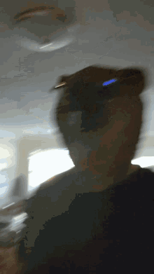 a blurry picture of a person 's face with a light behind them