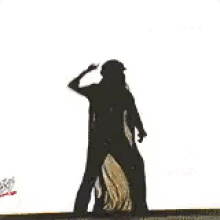 a woman is dancing on a stage in front of a crowd with a sign that says fight from the i