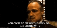 a man is talking on a cell phone and says `` you come to me on the week of my birthday ''