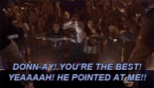 a man is standing in front of a crowd with the words " donnay you 're the best "