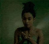 a naked woman is holding something in her hands and looking at it
