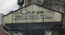 a building with a sign that says queen industrial inc. on it