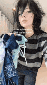 a girl is holding a bunch of clothes and a caption says cute suit options for the summer