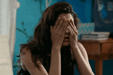 a woman covering her face with her hands with the caption " your aneja "