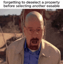 a bald man with glasses and a beard is wearing a jacket and a blue shirt .