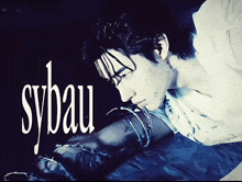 a man is laying on the ground with sybau written in white letters