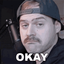 a man with a hat and a mustache says okay