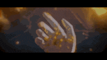 a close up of a person 's hand with gold dust on it
