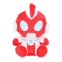 a red and white stuffed toy with a blue belt