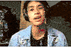 a young man wearing headphones and a denim jacket is making a face .