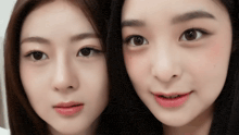 a close up of two women 's faces with their eyes looking at the camera