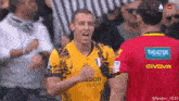 a soccer player wearing a givova jersey celebrates his goal