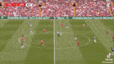 a soccer player kicking a ball on a field with the score 1-0