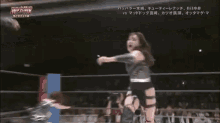 a woman in a wrestling ring with a foreign language on the bottom of the screen
