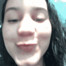 a close up of a woman making a funny face with her eyes closed