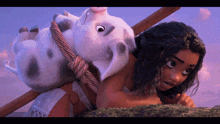 a woman with a pig on her back is looking at the camera