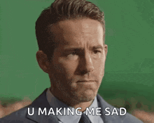 a man in a suit and tie is making a sad face and says u making me sad