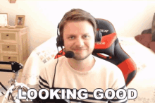 a man wearing headphones and a headset with the words looking good below him