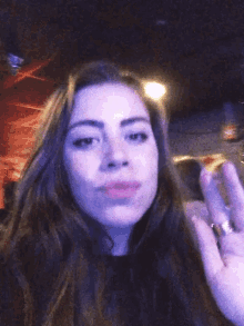 a blurry photo of a woman 's face with a purple background