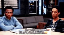 two men are sitting at a table and one says they are just jealous
