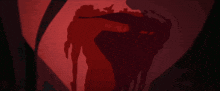 a silhouette of a person in a dark room with a red light behind them
