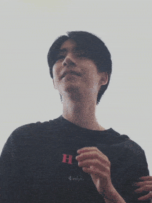 a man wearing a black shirt that says bs