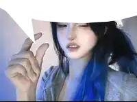 a girl with blue hair is holding a piece of paper