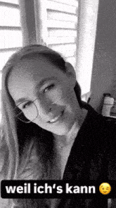 a black and white photo of a woman wearing glasses