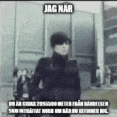 a blurry picture of a man standing in front of a building with a foreign language caption .
