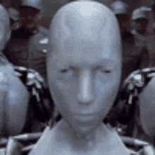 a group of robots are standing next to each other and one of them has a large head .