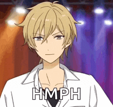 a man with blonde hair is wearing a white shirt with the word hmph written on it