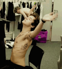 a shirtless man with a tattoo of a lantern on his chest